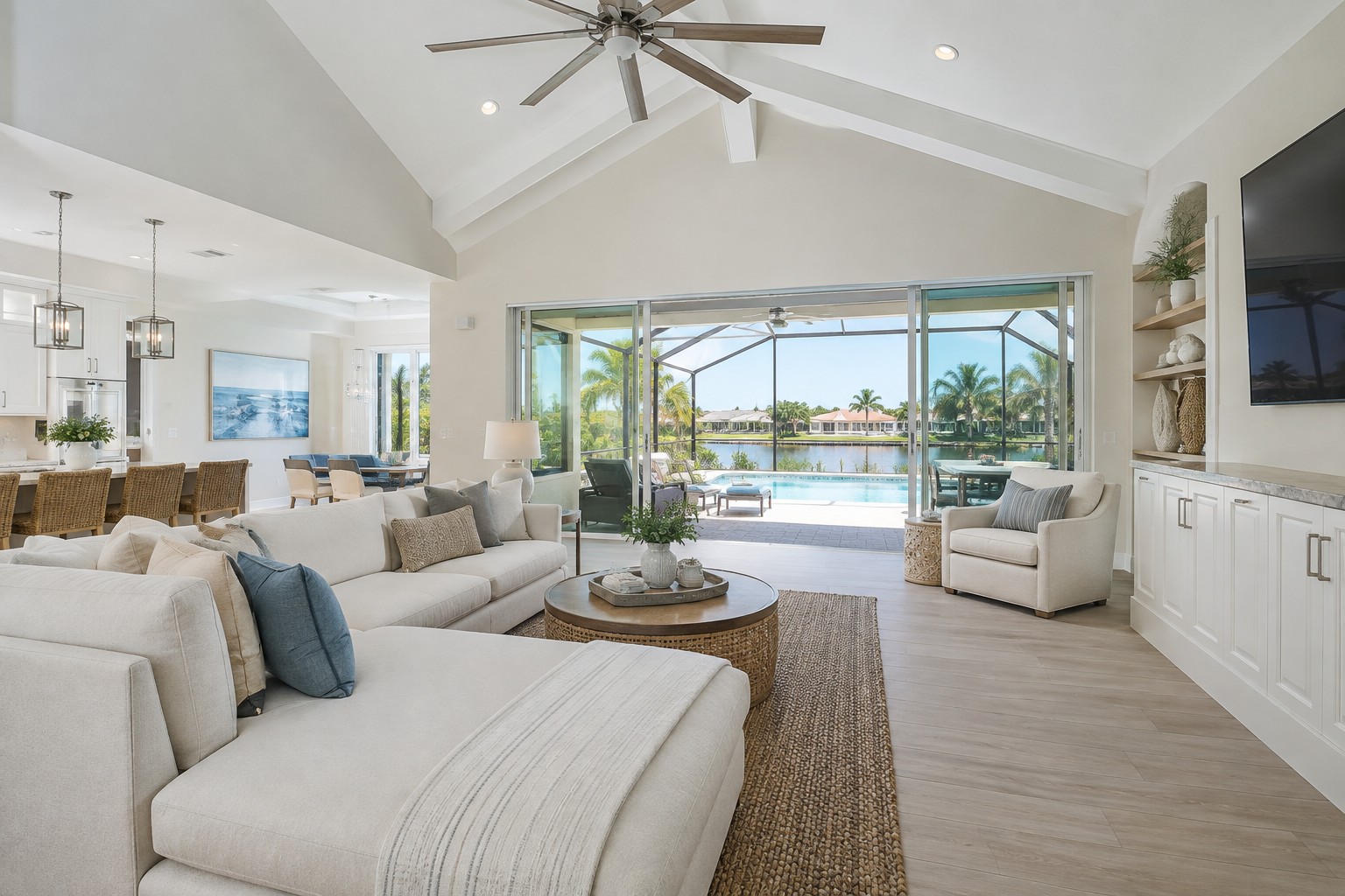 A bright Naples Florida living room opening to a lanai